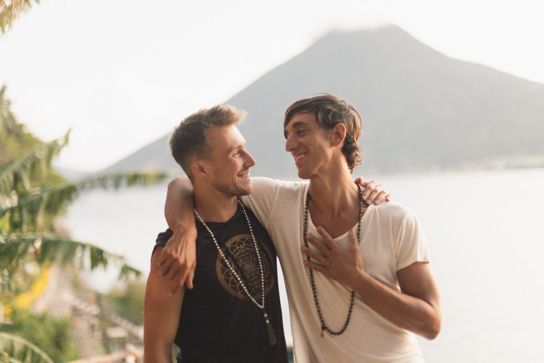 Two men laughing together above the lake in Guatemala